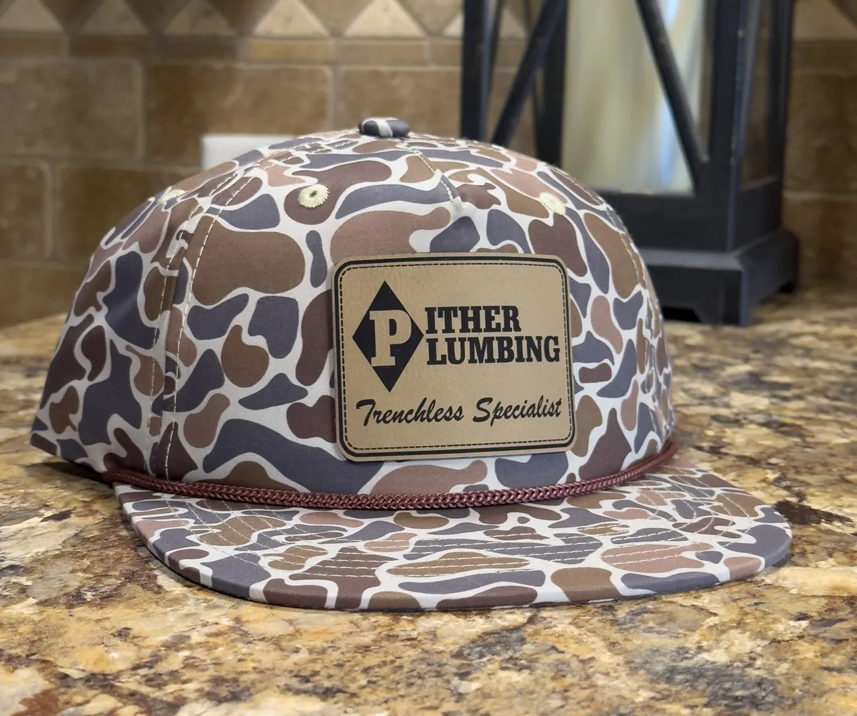 Custom camouflage hat with engraved leather Pither Plumbing patch